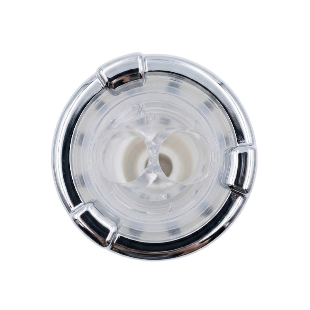 Direct overhead top-down view of a replacement swirl spa jet internal insert, featuring a polished chrome outer rim with three tab accents and a clear plastic face revealing twin directional nozzle openings.